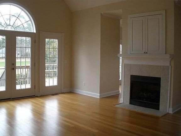 LIving room with gas fireplace. French doors open to large deck and 6th hole fairway on Belvedere golf course.