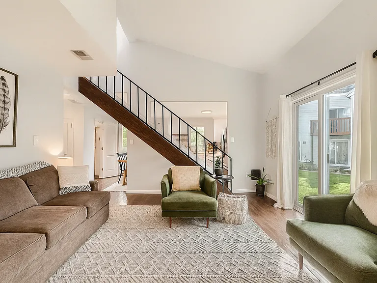Soaring ceilings, natural light, and plush seating create a cozy, open space perfect for relaxing or entertaining.