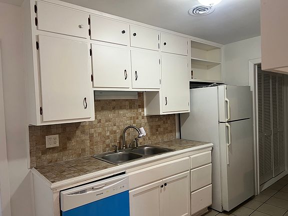 another view of kitchen with refrigerator and new DW