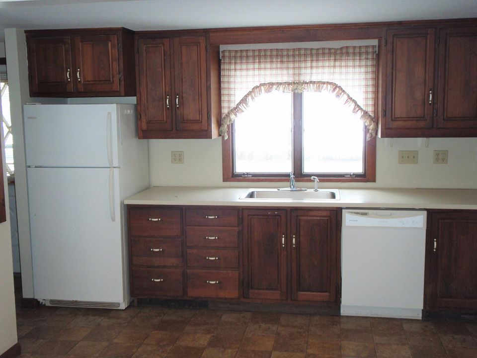 Kitchen has lovely hardwood cabinets, fridge, dishwasher and stove