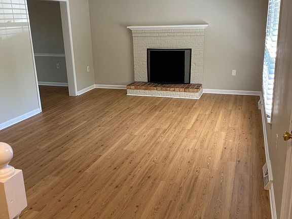 Living room with wood-burning fireplace.