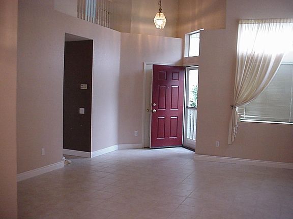 Looking from the dining room to the living room and front door.