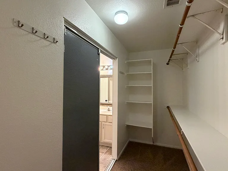 Primary Bath WIC with lots of space for lots of clothes & accessories