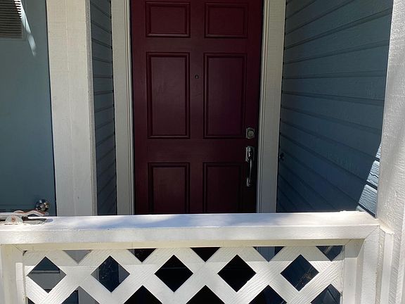 Front door & covered porch behind gate