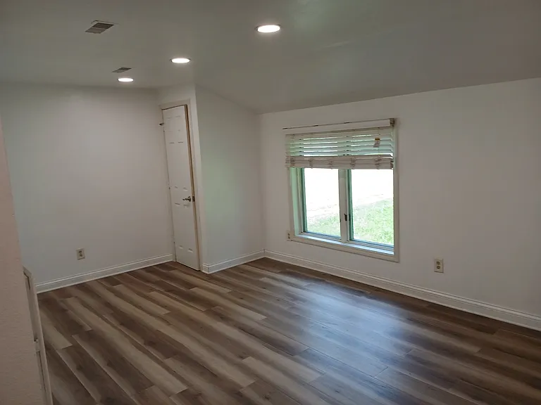 Living room with recessed l e d lights, hardwood, floors and blinds on all windows