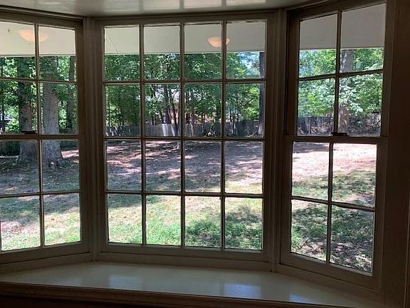 view of fenced in backyard from dining room bay window