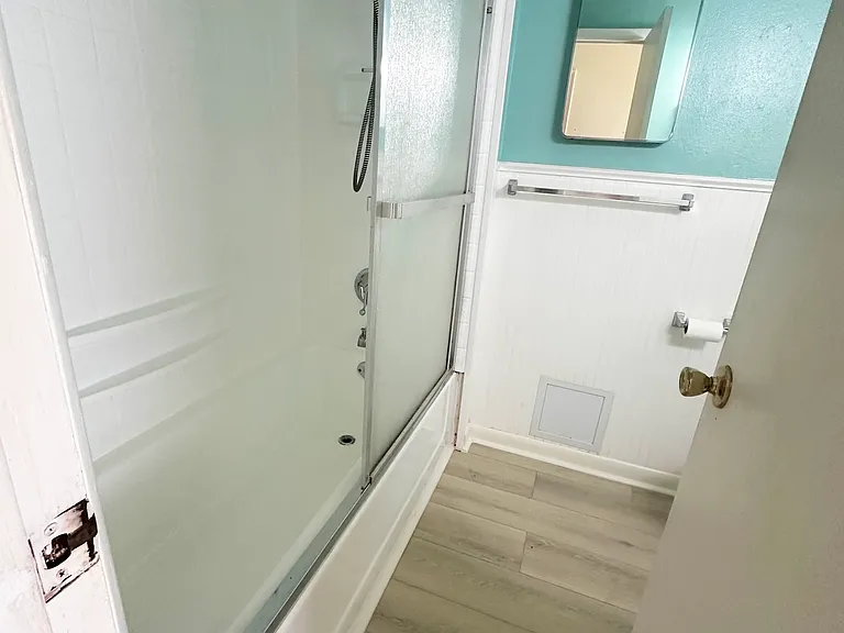 Bathroom. New flooring, toilet, vanity, and vent fan/light.