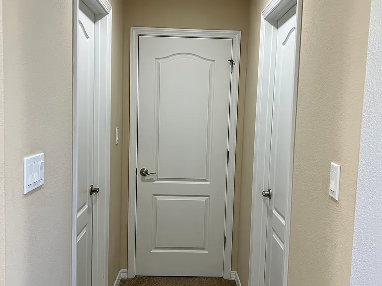 The two walk-in closets and hallway going to the bathroom