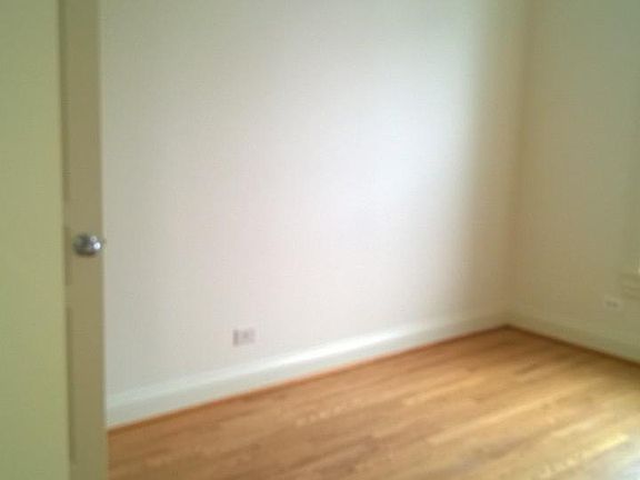 Bedroom with view of private building patio and garden