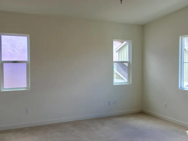 Master bedroom has plenty of natural lighting, with a walk-in closet and adjacent master bathroom.