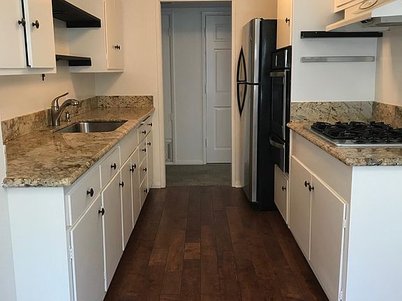 Kitchen with oven, gas range, and fridge