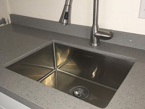 Sleek modern features. Stainless steel sink and granite.