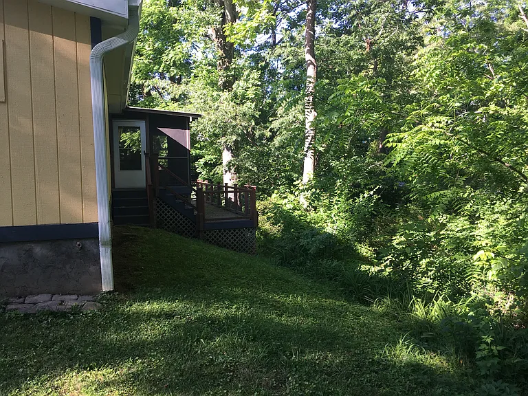 screened porch and deck space overlooking stream