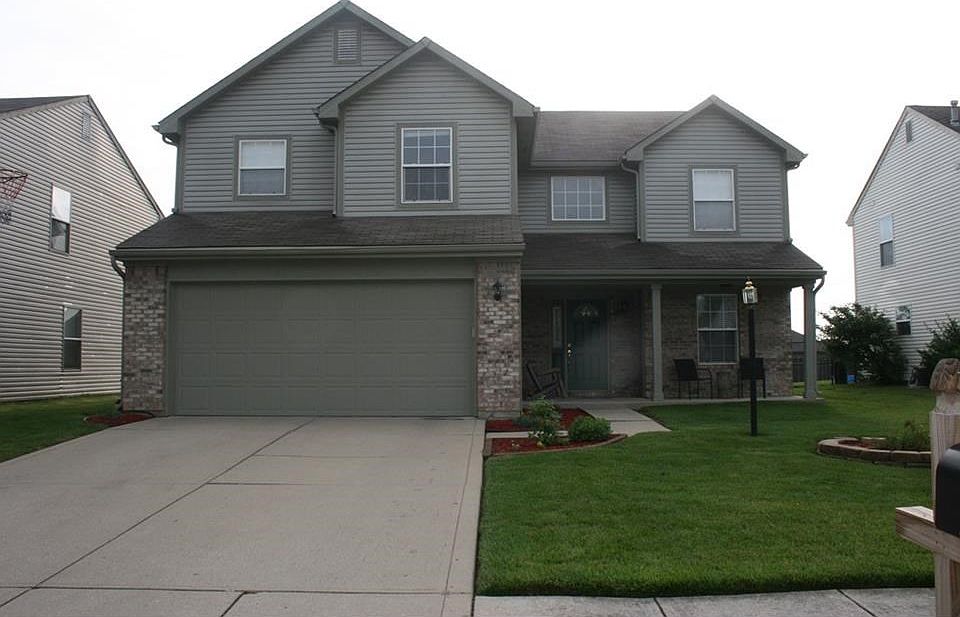 Beautiful curb appeal created by freshly painted exterior, and neat and tidy landscaping and lush green grass.