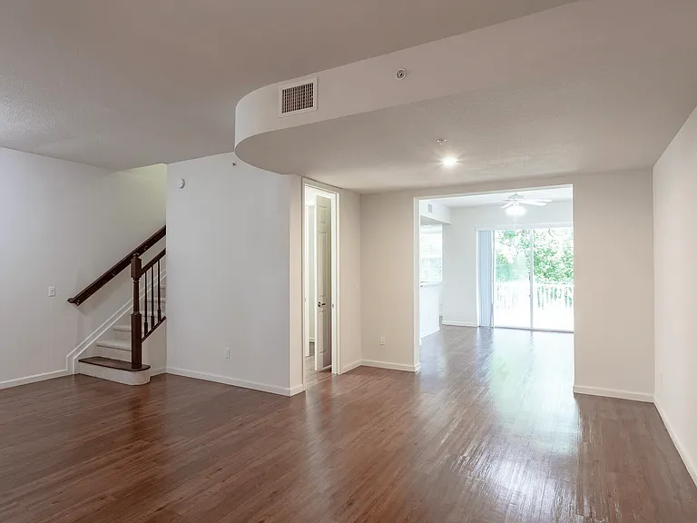 Remodeled split-level living space with natural light and hardwood floors.