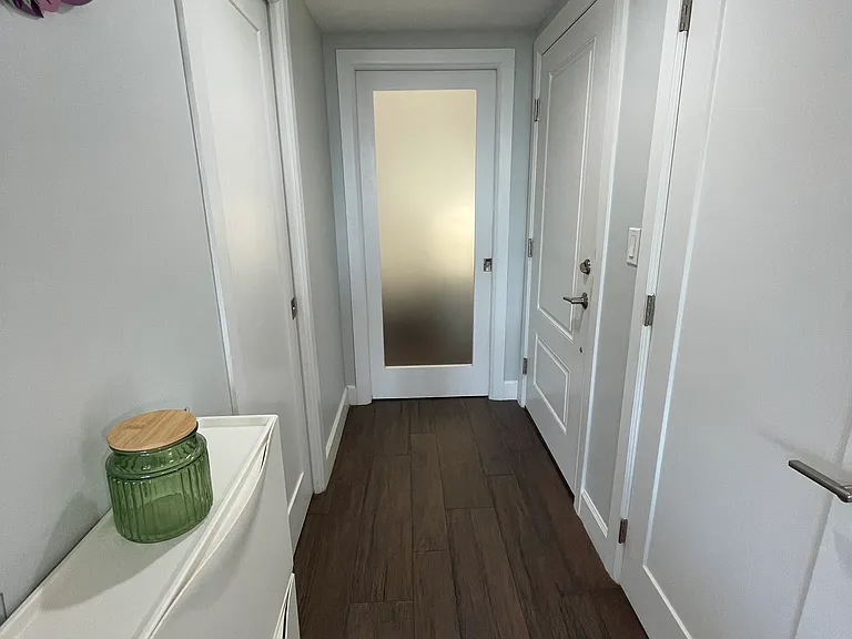 Hallway as interior closet and dropzone cabinet for keys and quick access items.