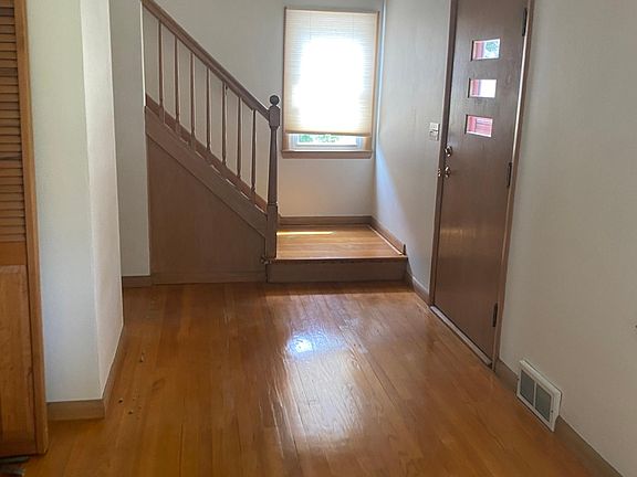 Living room with front door and stairs to bedrooms