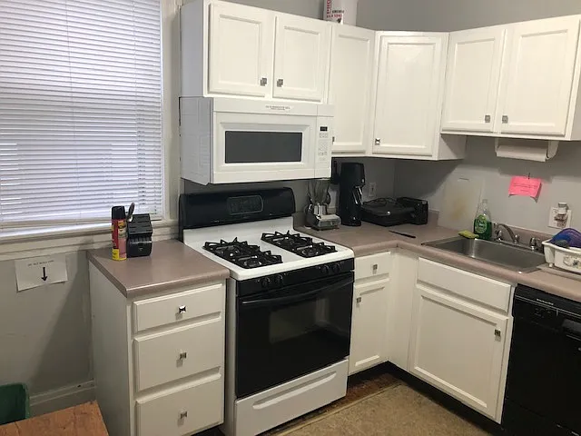 one side of kitchen, gas stove built in microwave and built in dishwasher