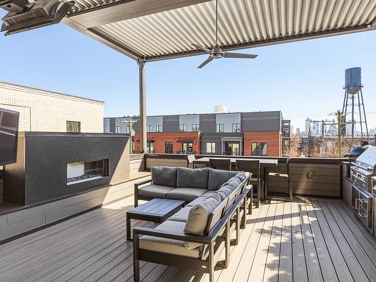 Spacious rooftop patio with a cozy fireplace, BBQ grill, outdoor TV, retractable Nano wall, adjustable louvered roof, LED lighting, wall heaters and plenty of lounge and dining seating_perfect for relaxing evening under the Nashville sky.