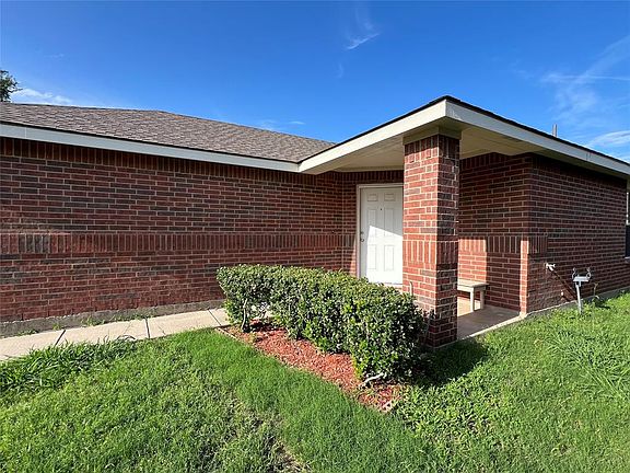 View of side of property with a yard
