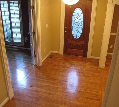 Hardwood Foyer with Heavy Moldings and doors to the Living a
