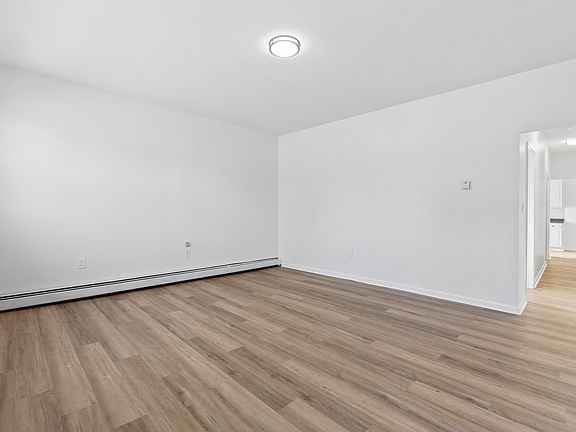 Living Room with brand new flooring, light fixture, newly painted.
