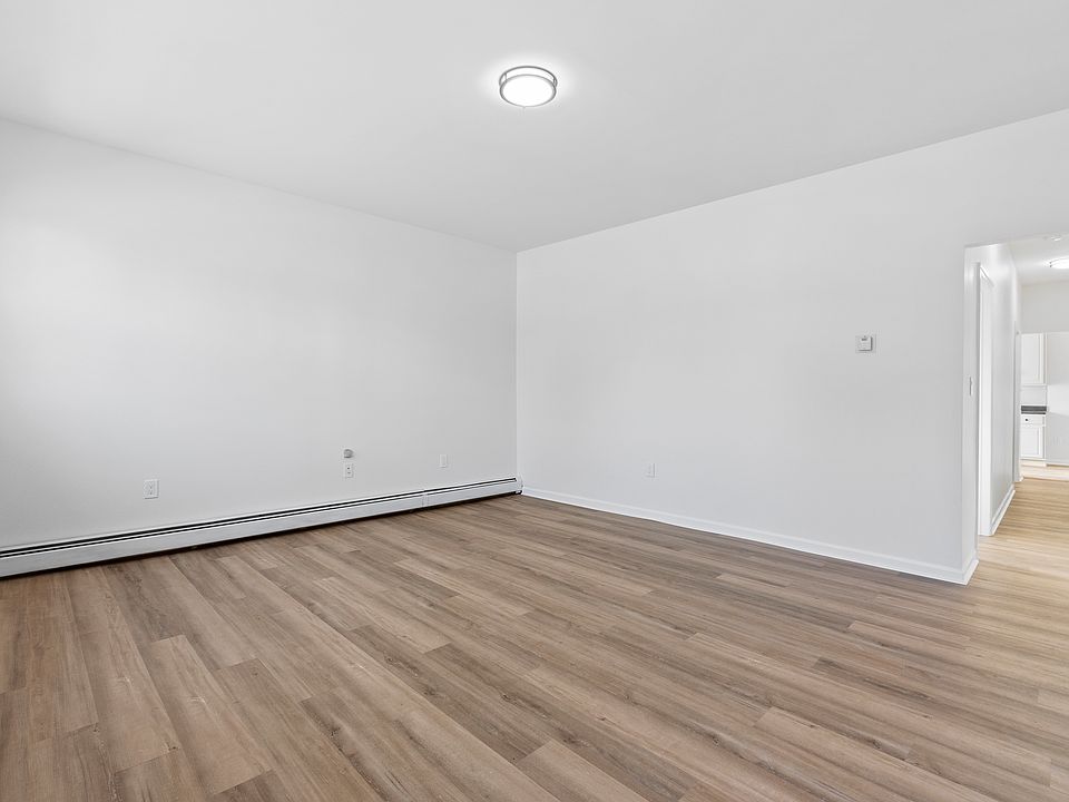 Living Room with brand new flooring, light fixture, newly painted.