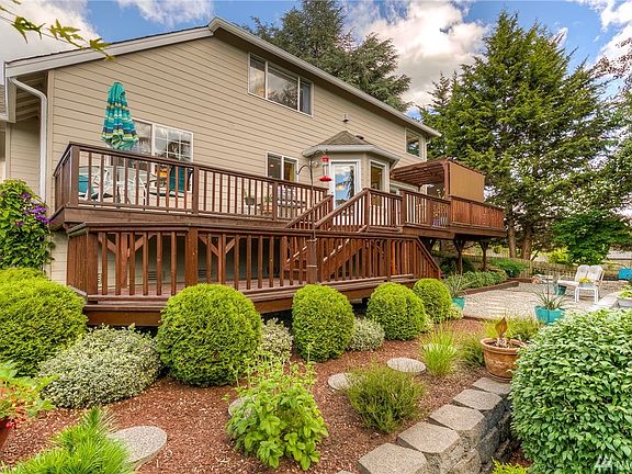 Exquisite backyard with double level deck, French Field drainage system & switch controlled electrical outlets for holiday lights in the peak locations.