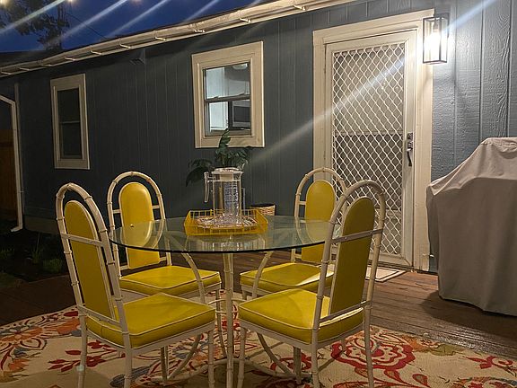 Backyard deck and 1 of the seating areas. Enjoy your coffee on back porch. Outdoor grill, string lights and fire pit for entertaining.
