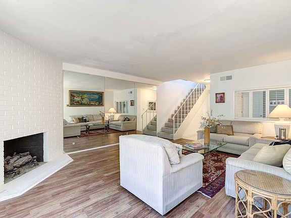 Living area with gas fireplace, with a mirror wall