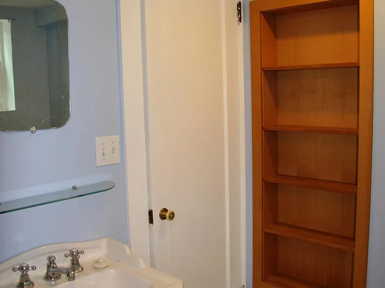 Basement bathroom with claw foot tub and fir built ins.