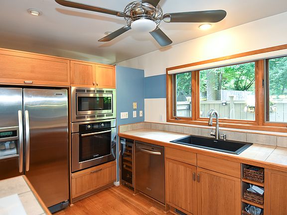 Large black granite composite sink with pull out sprayer. In sink dishwashing spigot. Built in microwave and oven (Bosch). Frost free side by side Kitchen Aid refrigerator/freezer with water/ice dispenser (with filter). Very quiet KitchenAid dishwasher.