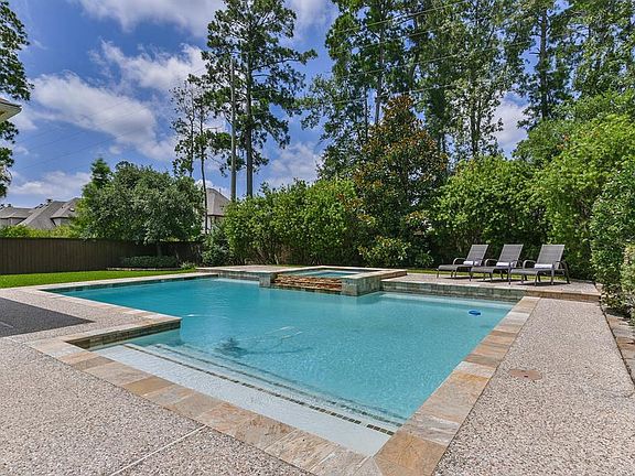 Splash in this sleek and sparkling pool with beautiful stone accents.