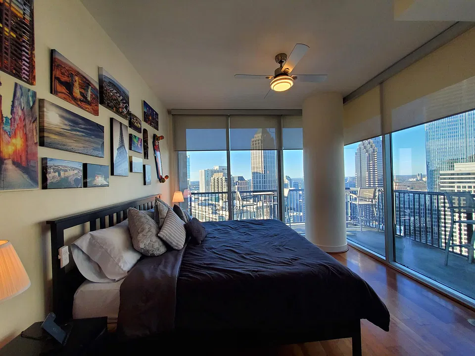 Second bedroom has 2 walls (west and north facing) of floor to ceiling windows with sliding door access to the wrap around balcony and manual shades. Condo come furnished and decorated as pictured.