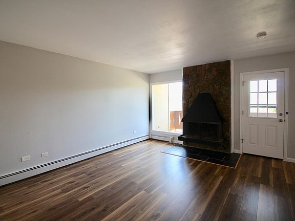 Living area with fireplace and access to private balcony