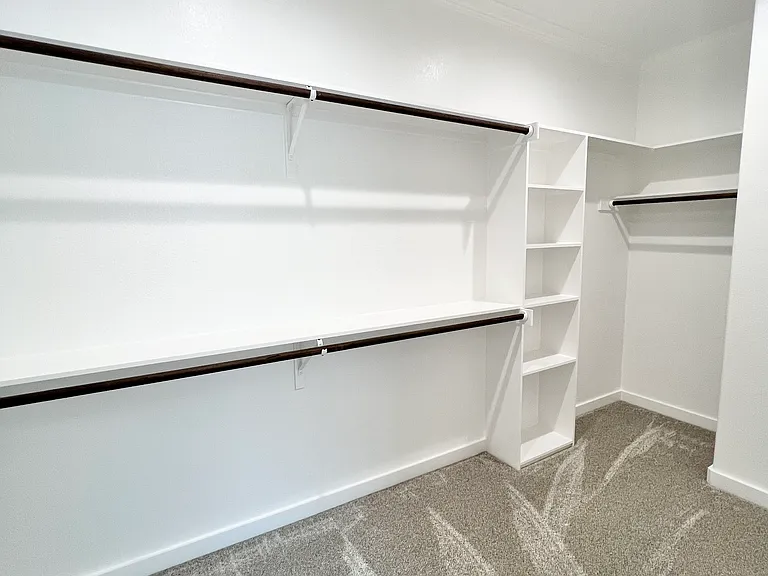 Large walk-in primary bedroom closet