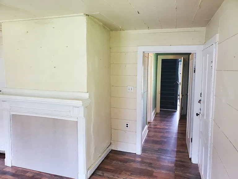 From kitchen, down hallway toward stairway
