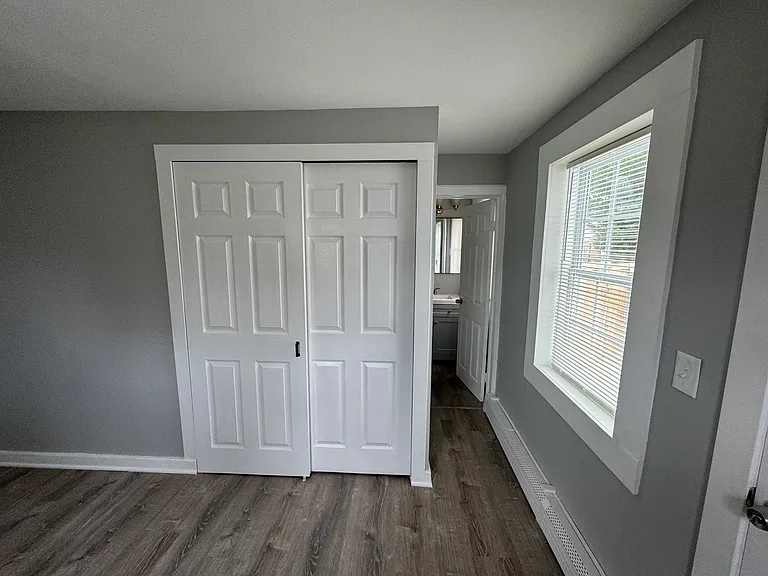 Washer/dryer behind doors, short walkway to bathroom.