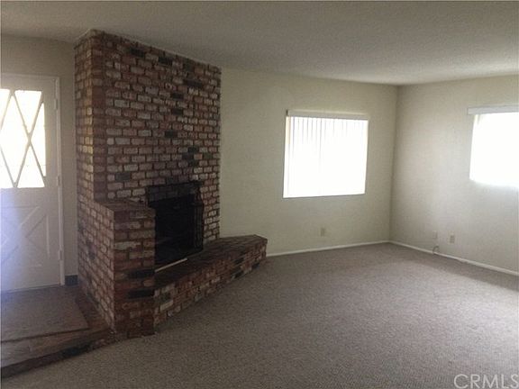 Spacious Living Room with Neutral Paint, Fireplace, A/C and Carpet