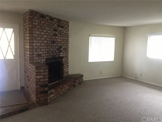 Spacious Living Room with Neutral Paint, Fireplace, A/C and Carpet