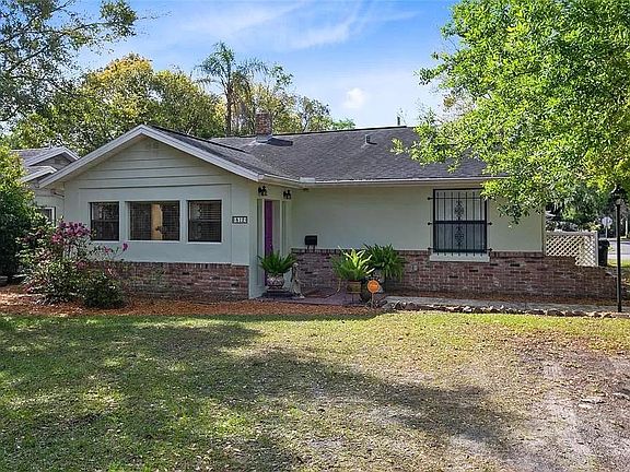 The house has been painted white with black trim. Also has a new paved driveway