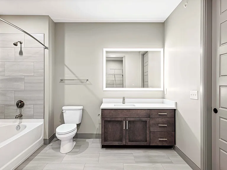 Bathroom with large vanity and lighted mirror