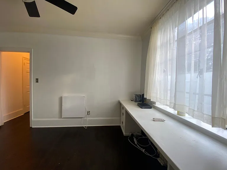 the built-in desk has since been removed to allow for even more space. we added wood blinds and floor-length curtains for added privacy!