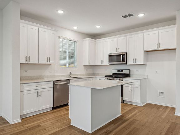 Spacious kitchen with oversized island real home pictured