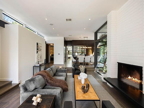 Unwind in the spacious living room, furnished with plush sofas and equipped with a state-of-the-art entertainment system.