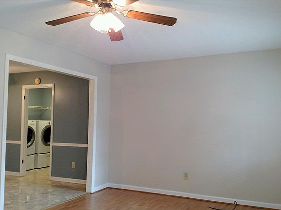 Living room leading into the dining/kitchen area. Separate laundry room with door leading to garage.