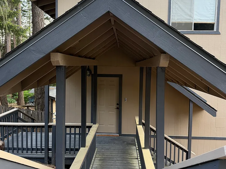 Covered entry leading to street parking area and mailbox