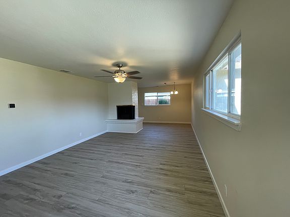 Large family room and dining nook. Fireplace and ceiling fans.