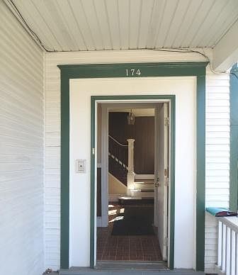 Entranceway to rental property with open door looking into foyer