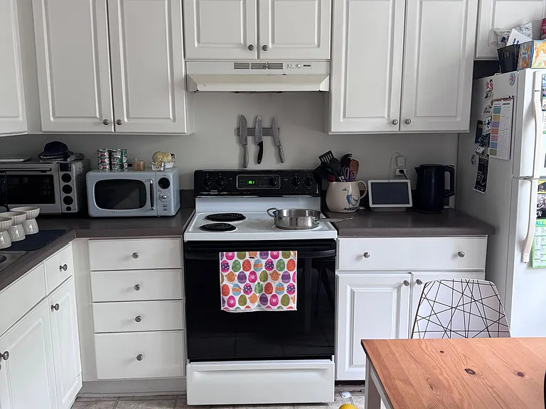 Functional kitchen with ample cabinet storage, full-size range, and generous counter space for everyday cooking.